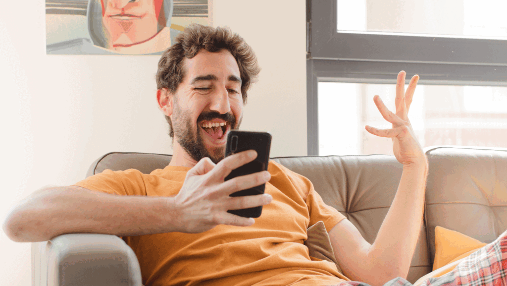 Men Laughing Holding Phone.